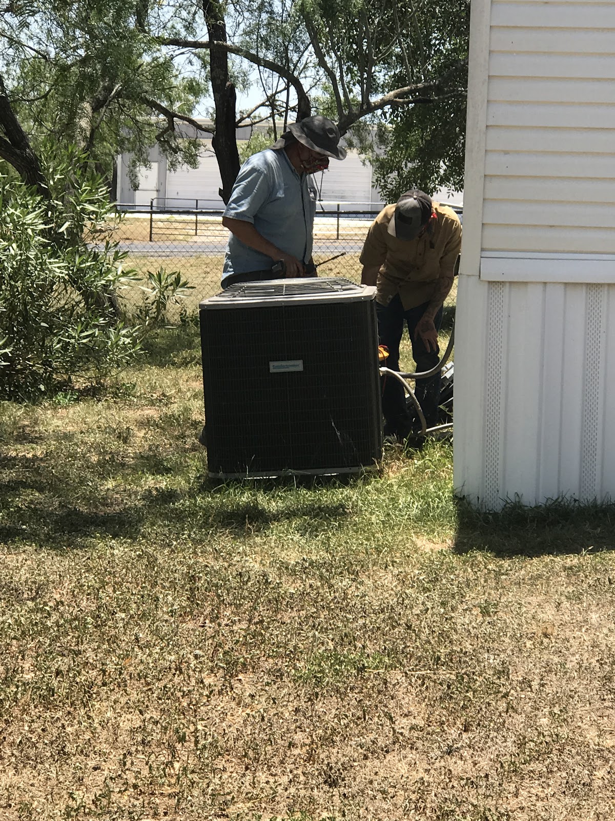 AirPros team working on an outdoor condenser unit